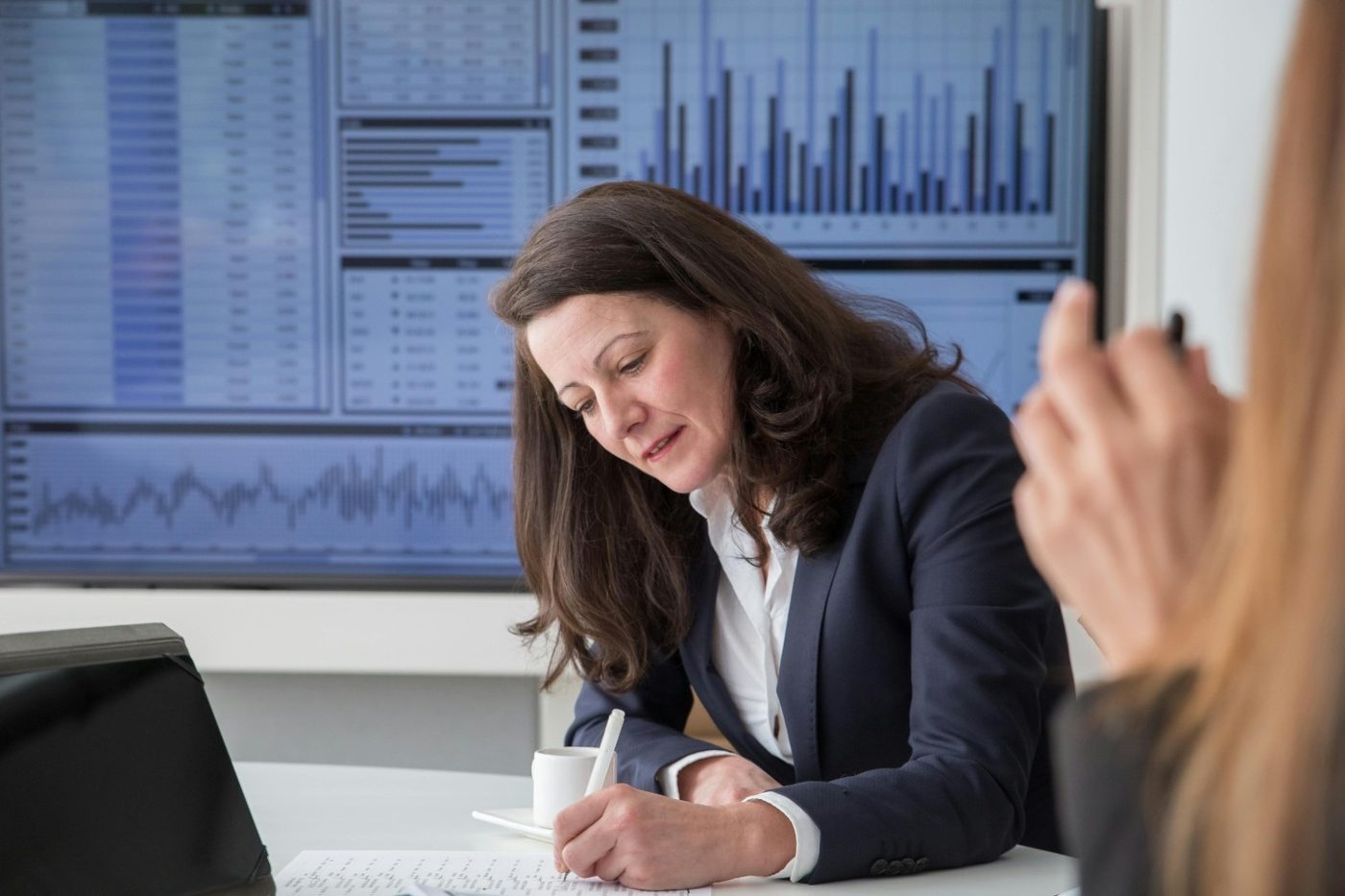 An underwriter reading a bank statement at her desk